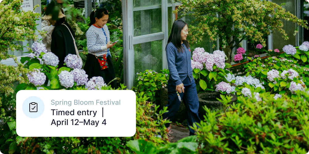 Visitors walking through a greenhouse showing Muse timed entry for botanic garden events. Action Tag reads: Spring Bloom Festival, Timed entry | April 12-May 4.